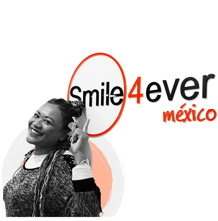 Tijuana dental center black woman patient smiling with her dental implants restoration in Mexico