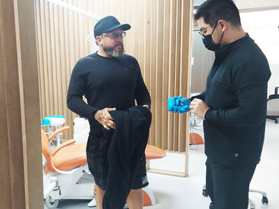 dentist in Mexico talking with the patient in english